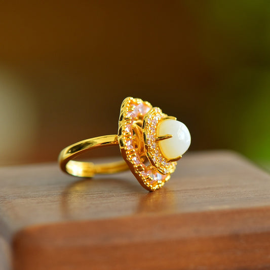 Gold ring with a pearl on a wooden surface