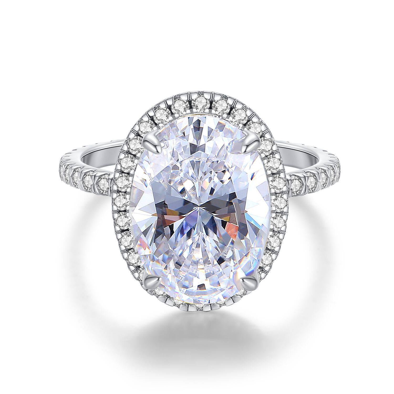 Diamond ring with a large central gemstone and smaller stones around on a white background