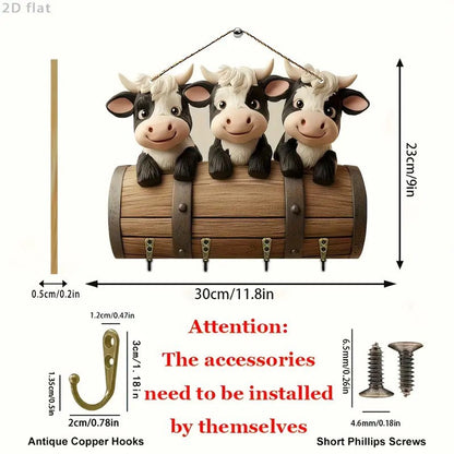 Decorative wall hook with three cow figurines and measurements on a white background