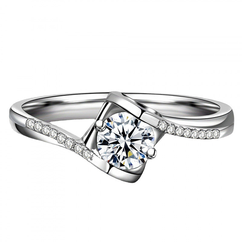 Silver ring with a diamond on a white background