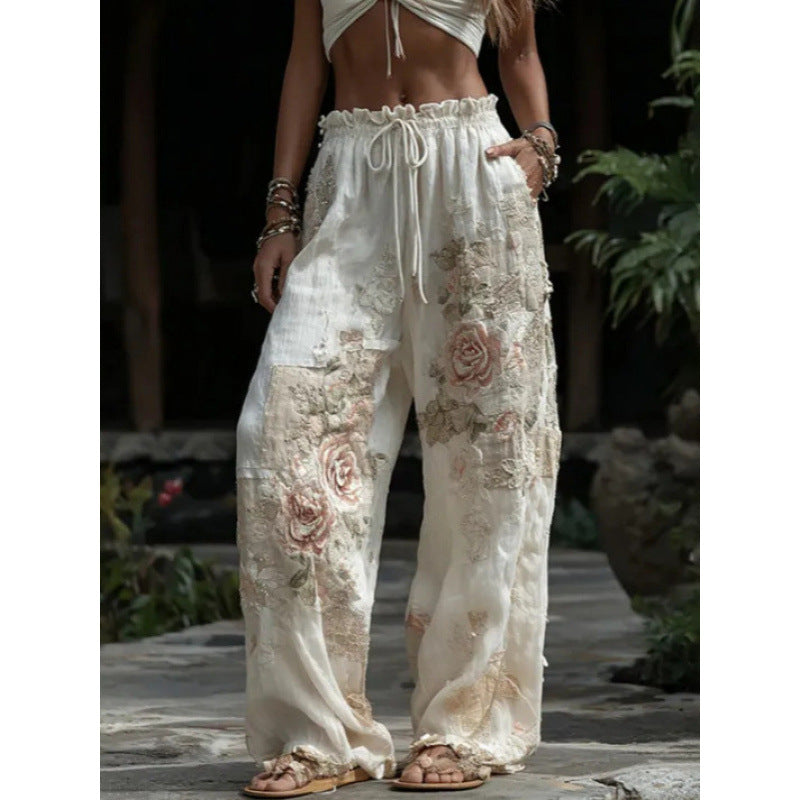 Person wearing floral-patterned white pants in an outdoor setting