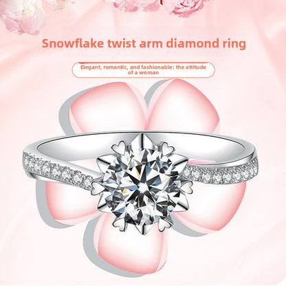 Snowflake twist arm diamond ring on a pink floral background