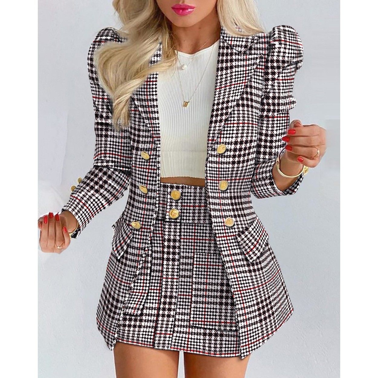 Woman wearing a black and white checkered blazer and skirt set on a light gray background